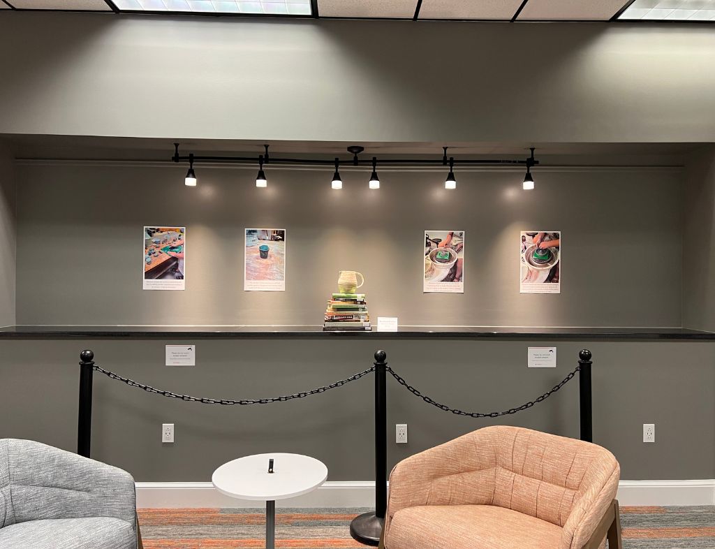 Shannon Towey Exhibit displaying Marbled Pitcher and the marbling process on the wall behind.